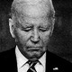 Grainy black-and-white photo of an older man in a suit looking sad.