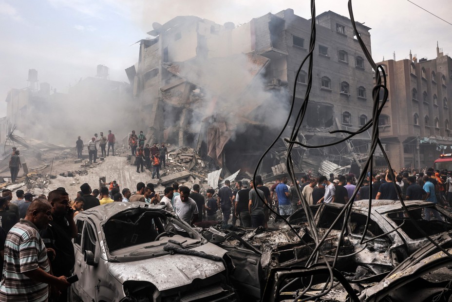 Picture of Palestinians searching for survivors after an Israeli airstrike on buildings in the refugee camp of Jabalia in the Gaza Strip on October 9, 2023. Israel relentlessly pounded the Gaza Strip early Monday as fighting raged with Hamas around the Gaza Strip and the death toll from the war against the Palestinian militants surged above 1,100.