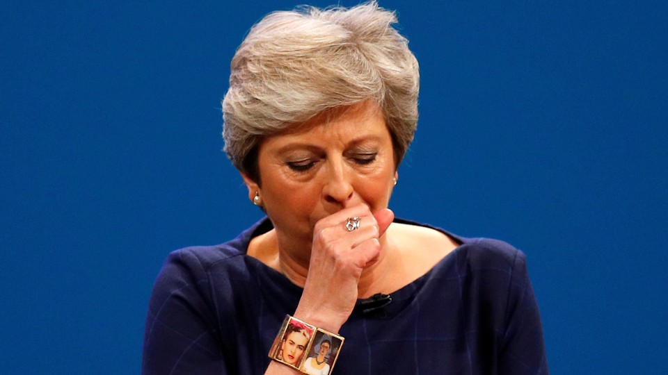 Prime Minister Theresa May coughs as she addresses the Conservative Party conference.