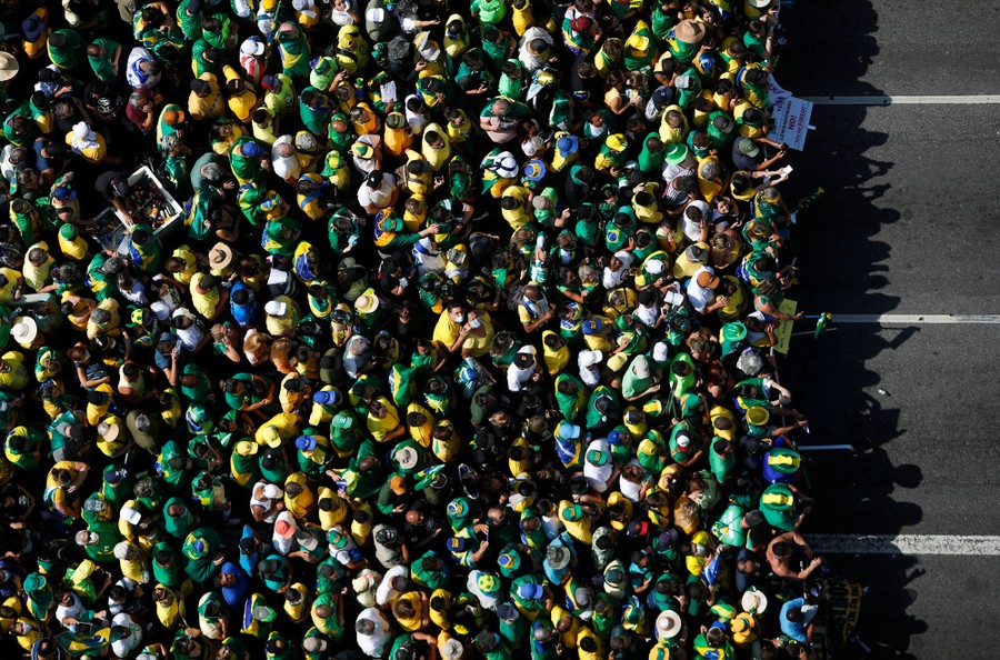 An aerial view of hundreds of political supporters gathered on a road