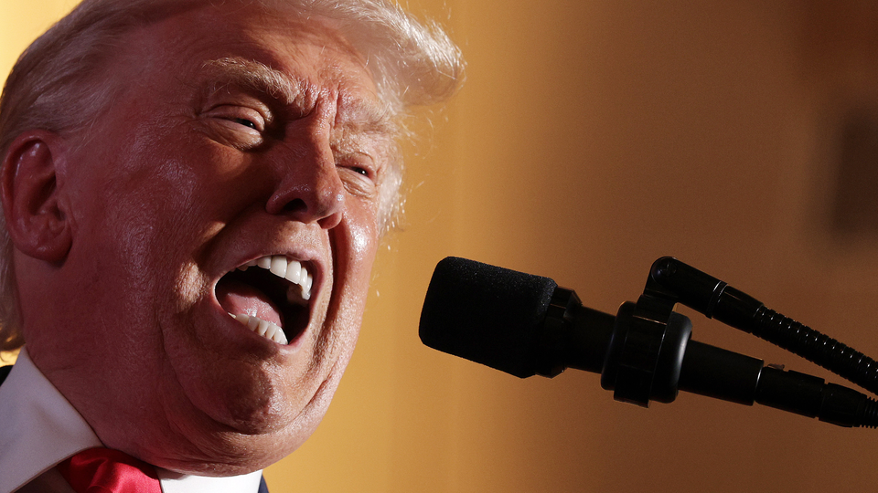 Trump speaking into mic