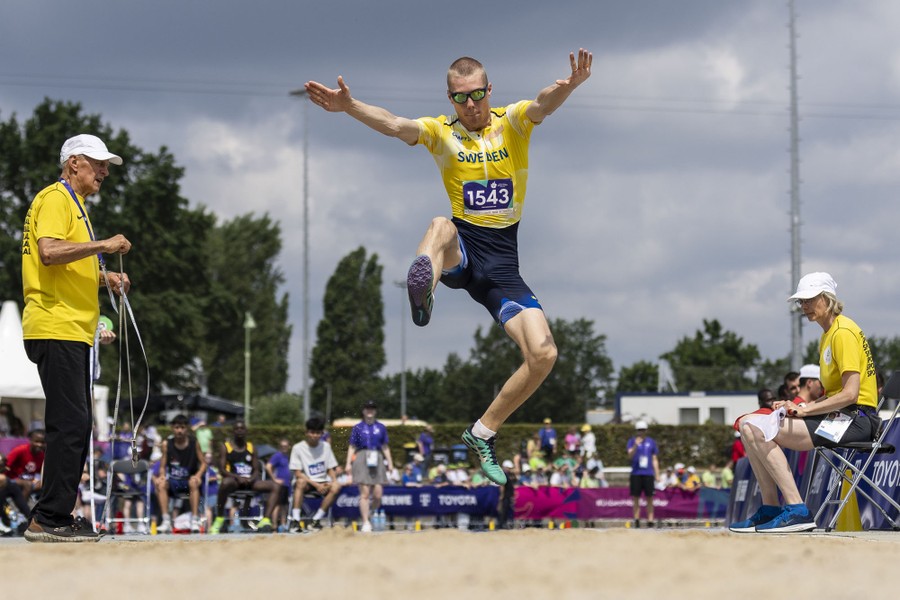 An athlete makes a long jump.