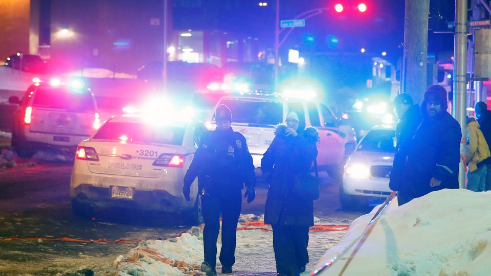 Police officers are seen near a mosque after a shooting in Quebec City on January 29, 2017.