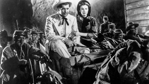Rhett Butler and Scarlett O’Hara ride through a group of retreating Confederate troops in the 1939 film adaptation of Gone With The Wind