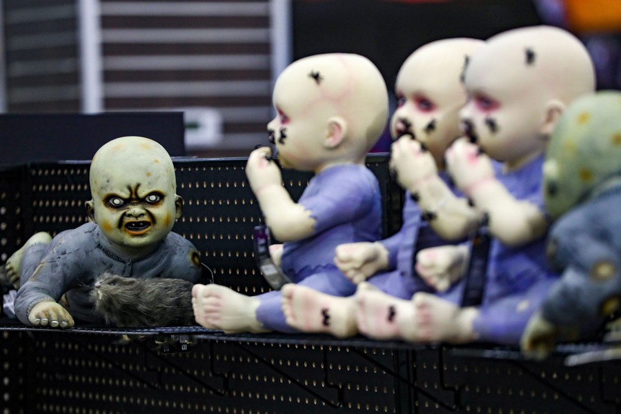 Several figures depicting creepy monster babies sit on a store shelf.