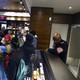 Demonstrators gather in a Starbucks as a police officer watches them.