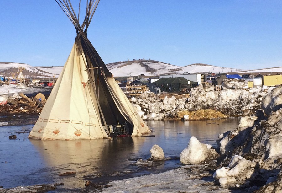 In this February 16, 2017, photo, an abandoned teepee is surrounded by melted snow at the Dakota Access oil pipeline protest camp. The camp is on federal land, and authorities told occupants to leave by Wednesday, February 22 in advance of spring flooding.