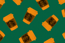 Orange-colored Starbucks cups on a green background