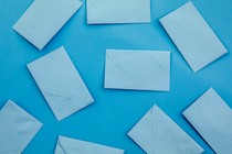 Multiple blue envelopes on a blue background