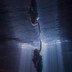 Halle Bailey, as Ariel, touches the surface of the ocean from below in "The Little Mermaid."