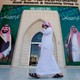 A man speaks on the phone as he walks past posters depicting Saudi Arabia's King Salman bin Abdulaziz Al Saud and Crown Prince Mohammed bin Salman.