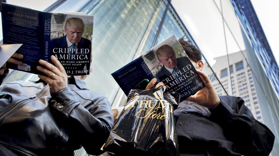 Two people photographed from below read Donald Trump's book, "Crippled America."