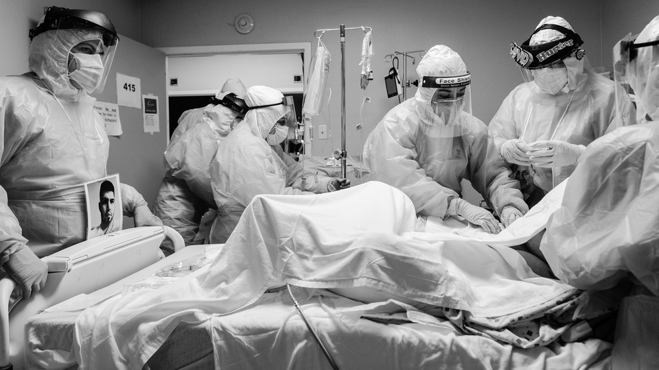 Doctors wearing PPE surrounding a coronavirus patient.