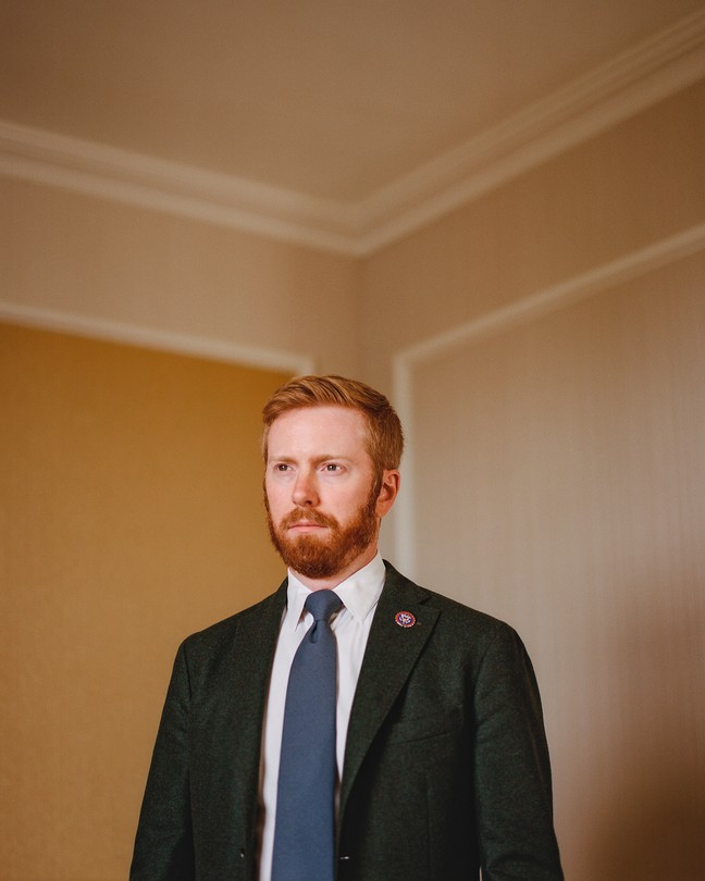 portrait photo of Peter Meijer in suit jacket with blue tie and lapel pin