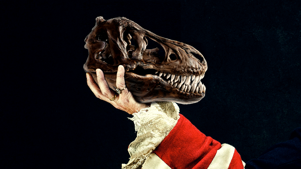 dinosaur skull held up by an arm