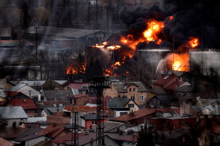 Large tanks burn near a residential area.