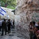 Israeli border policemen secure an alley as Israeli youth march on their way to the Western Wall.