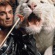 A photograph of Siegfried & Roy feeding a white tiger