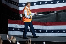 Donald Trump wears a garbage vest onstage