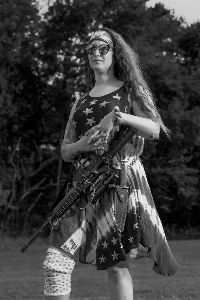 Armed militia member in stars and stripes dress