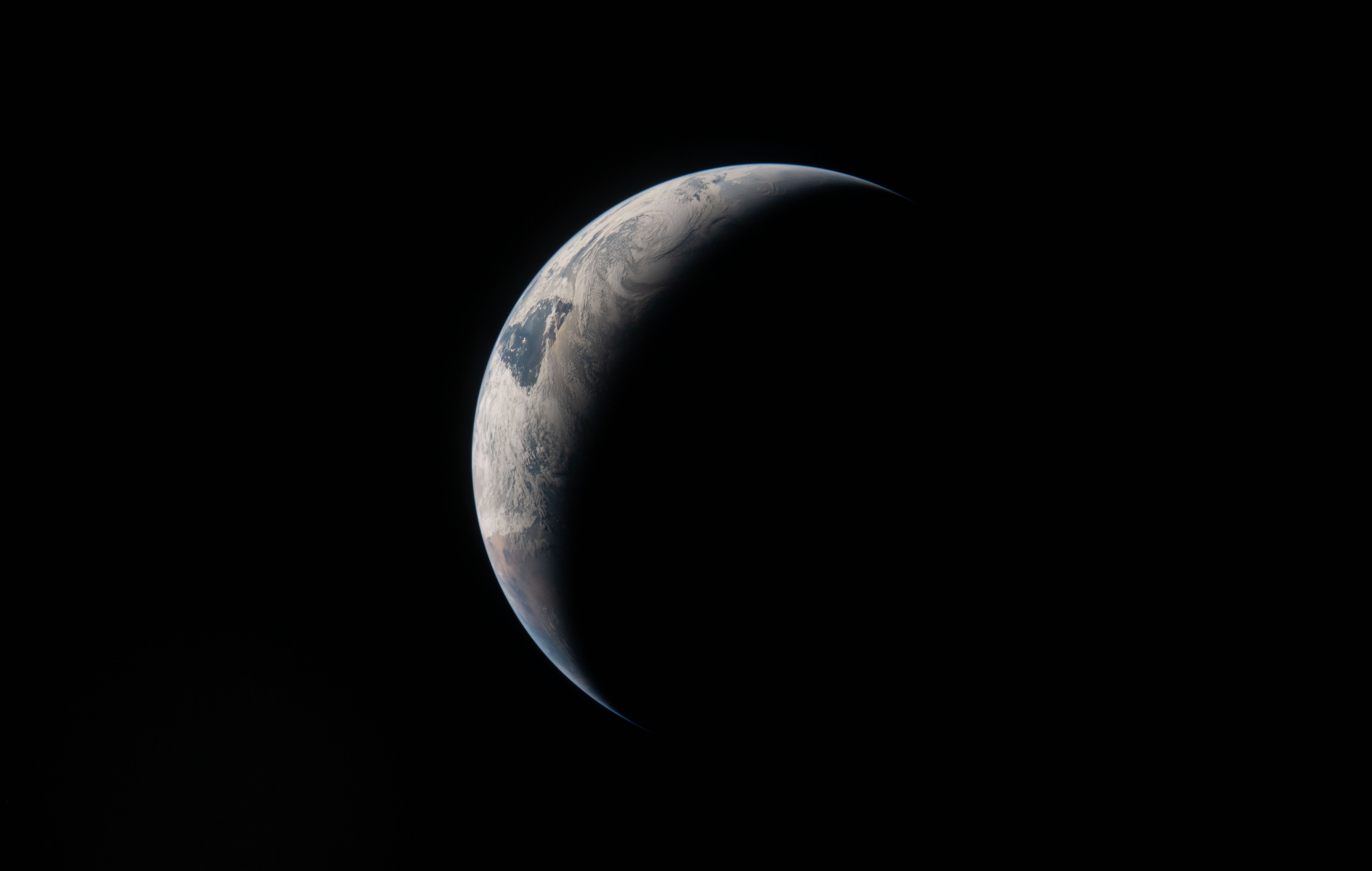 A view of the crescent Earth, seen from a distance
