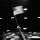 Black-and-white image of a person waving an American flag