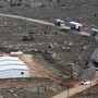 Trucks removing pre-fabricated homes drive along a road leading out of the recently evicted Israeli settler outpost of Amona.