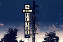 A hotel sign says “The Dream Hotel,” with surveillance cameras around it