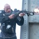 Dwayne Johnson shoots a gun in "Red Notice"