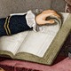 An old illustration of a hand turning a book's pages