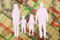 A silhouette of a nuclear family set against a map