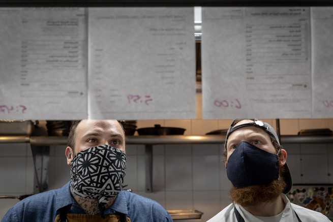 Two chefs preparing orders.