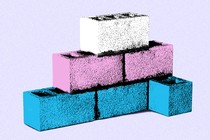 White, blue, and pink cement bricks stacked in a pyramid