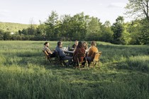 People sitting a table in a park