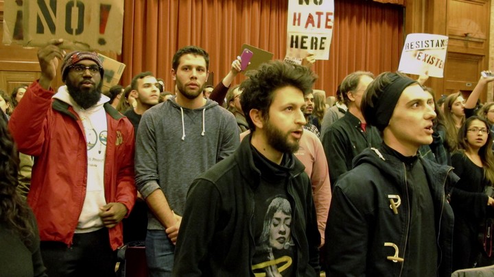 People hold signs reading "No!" and "No hate here"