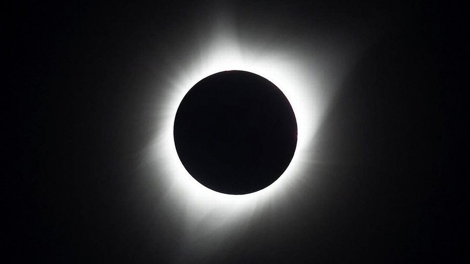 A photograph of the total solar eclipse in 2017, with the sun's corona glowing brightly against a dark sky