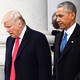 Donald Trump and Barack Obama walk and talk at the U.S. Capitol grounds. A marble pillar can be seen behind them.