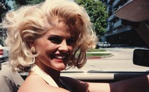 A profile shot of Anna Nicole Smith, driving a car.