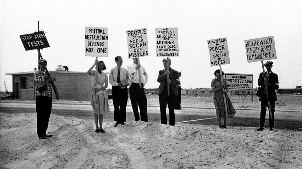 A black-and-white photo of antinuclear protesters holding signs in Cape Canaveral, Florida