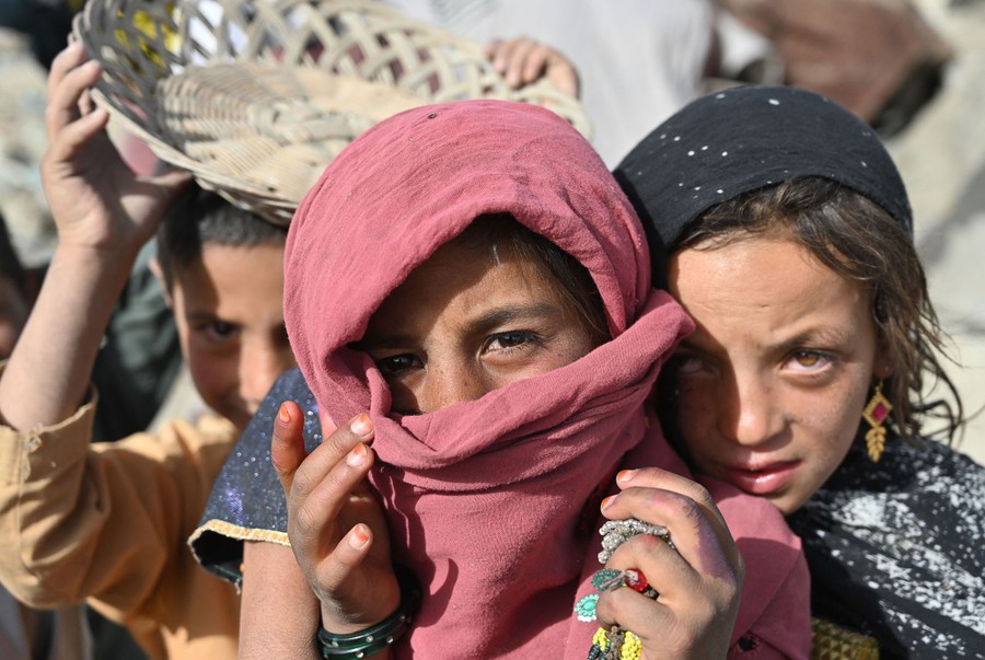Several Afghan children gather in front of the photographer.