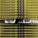 illustration of someone peeking through yellow tape labeled "quarantine"