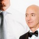 Jeff Bezos stands in front of a poster of himself