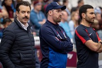 A landscape photo of Ted Lasso, Coach Beard, and Roy Kent from the TV show "Ted Lasso"