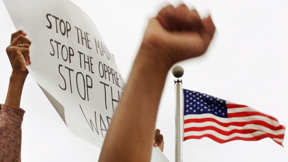 Protesters raising fists and signs