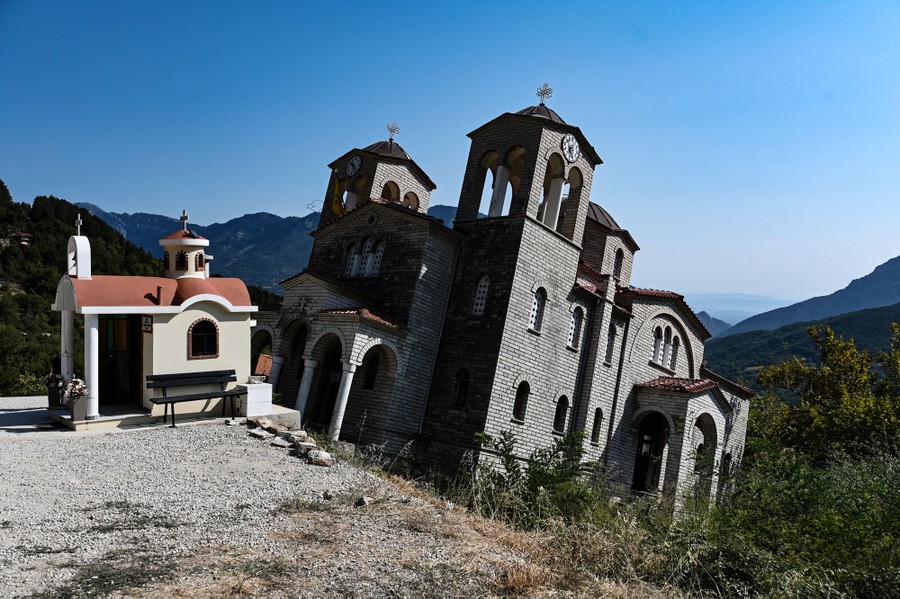 A small church sits on a slope, tilted at a sharp angle.