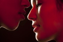 A close up of two people about to kiss