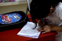 A girl writes a letter. 