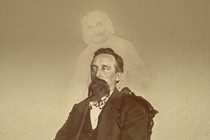 A vintage photo of a bearded man with the ghostly image of another person superimposed