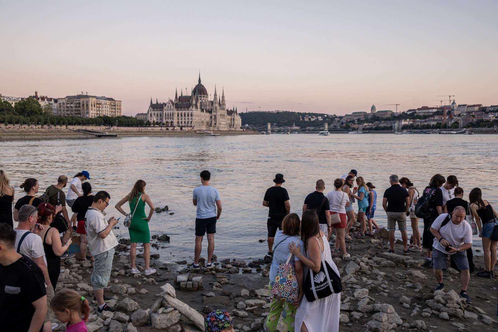 Visitors gather on an exposed section of riverbed during a heatwave in Budapest.