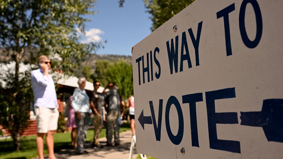 People arriving to vote in the Republican primary election in Wilson, Wyoming, on August 16